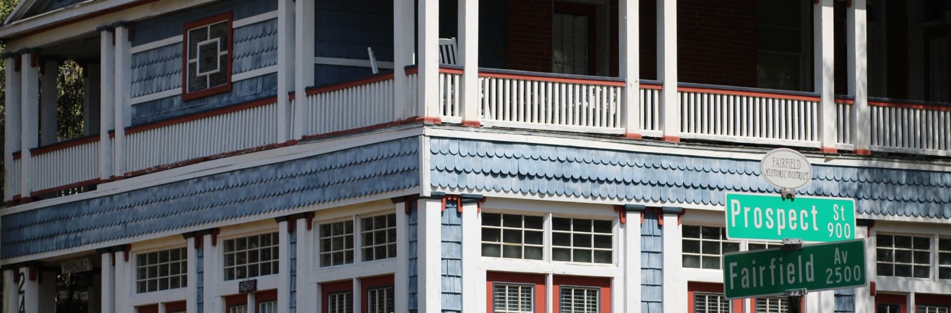 A historic blue and white building with a porch, located at the intersection of Prospect Street and Fairfield Avenue.